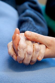 Elderly hand in a young hand